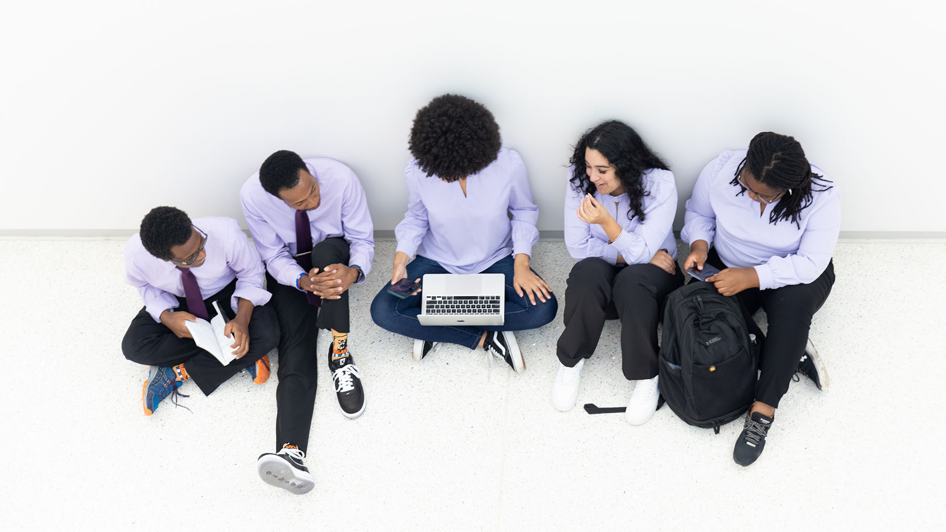 students gathered around laptop