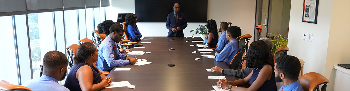 President Wilson at a board table with leadership students