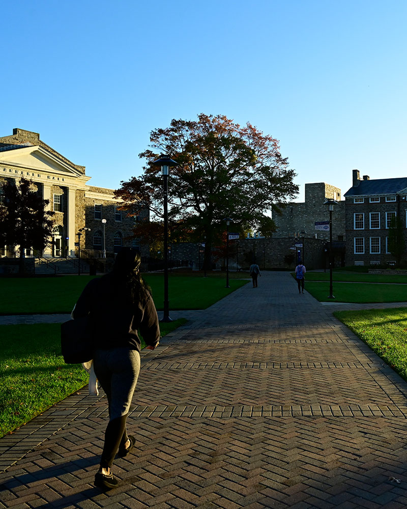 student walking down sidewalk