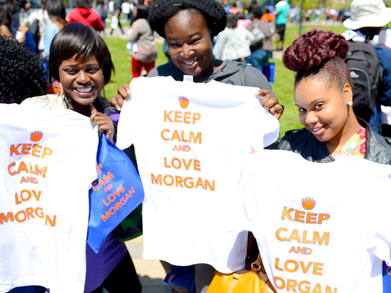 three students holding with keep calm and love Morgan tee shirt