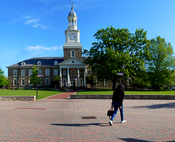 student walking across the quad