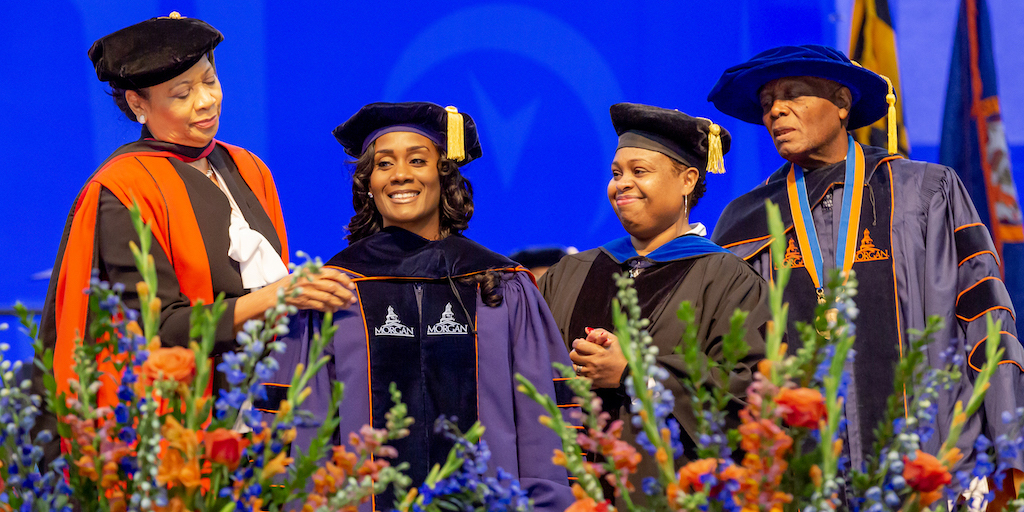 Woman receiving her hood at commencement 