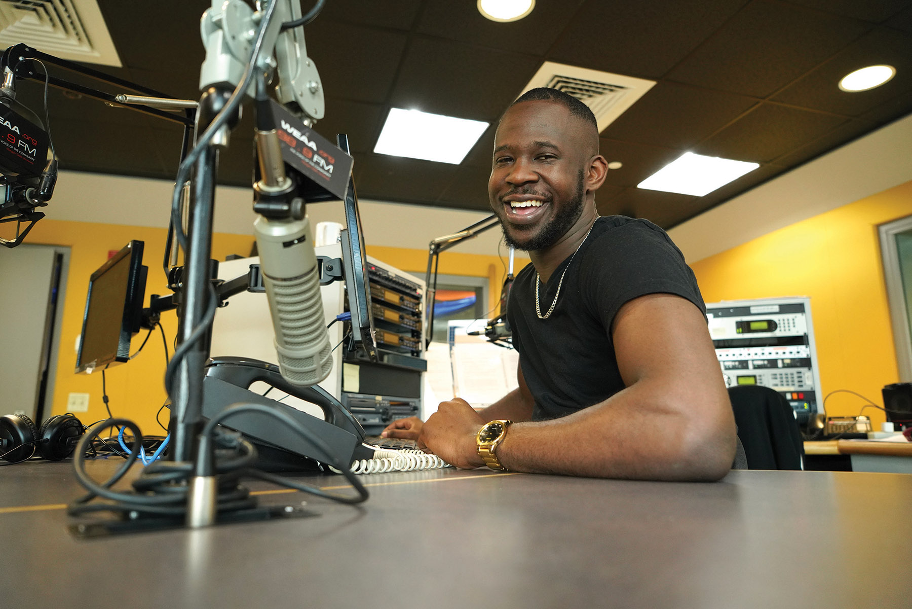 student at microphone inside radio station