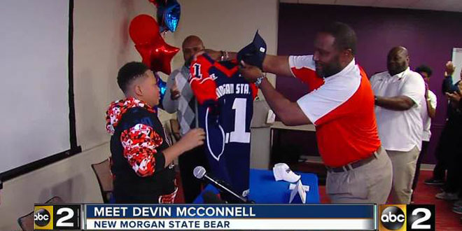 young boy receiving Morgan State football jersey