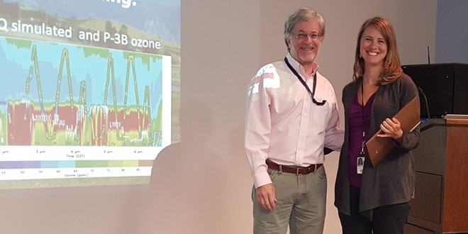 two staff persons smiling