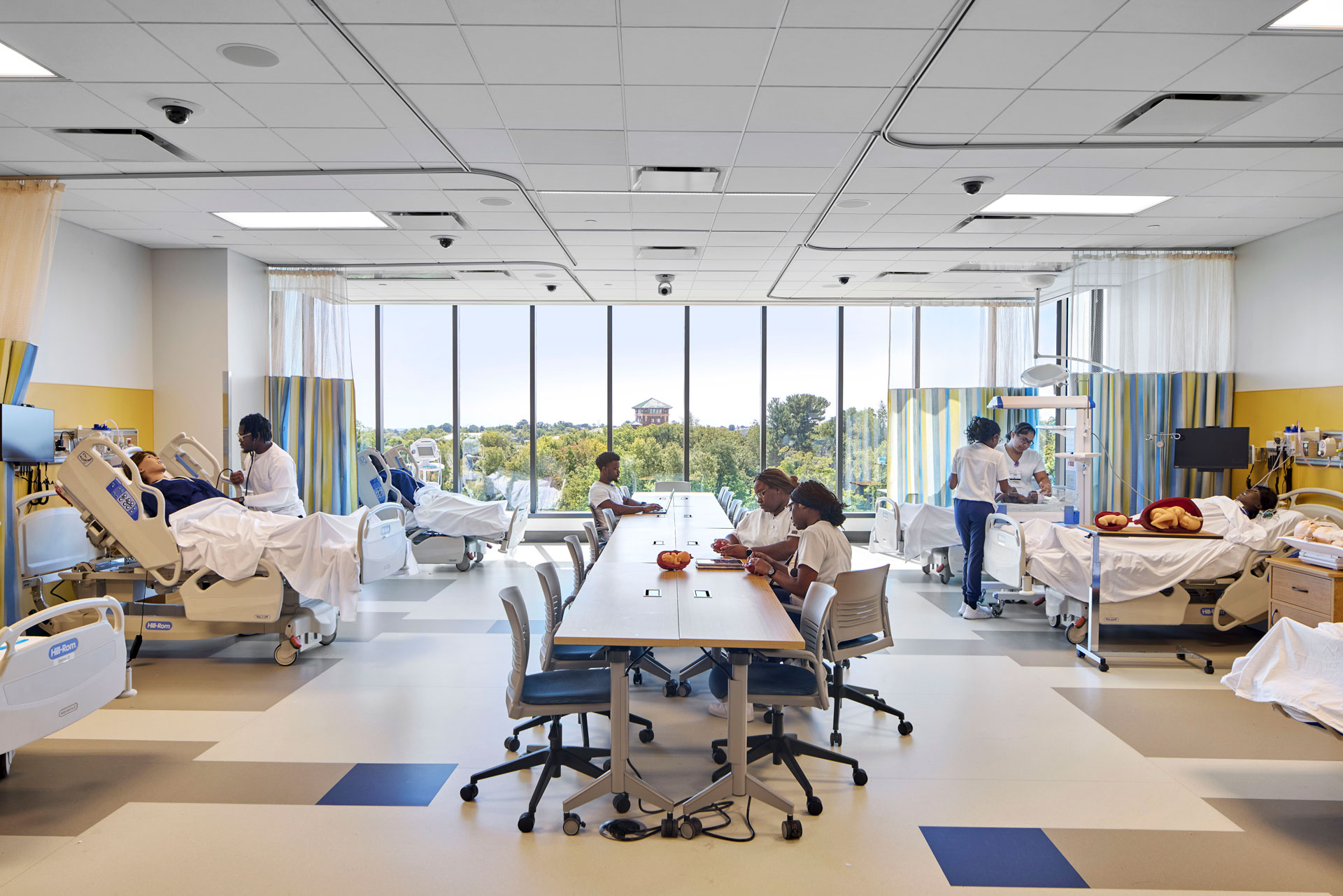 Nursing students at Morgan State University participate in hands-on training inside a state-of-the-art simulation lab equipped with hospital beds, medical mannequins, and clinical equipment